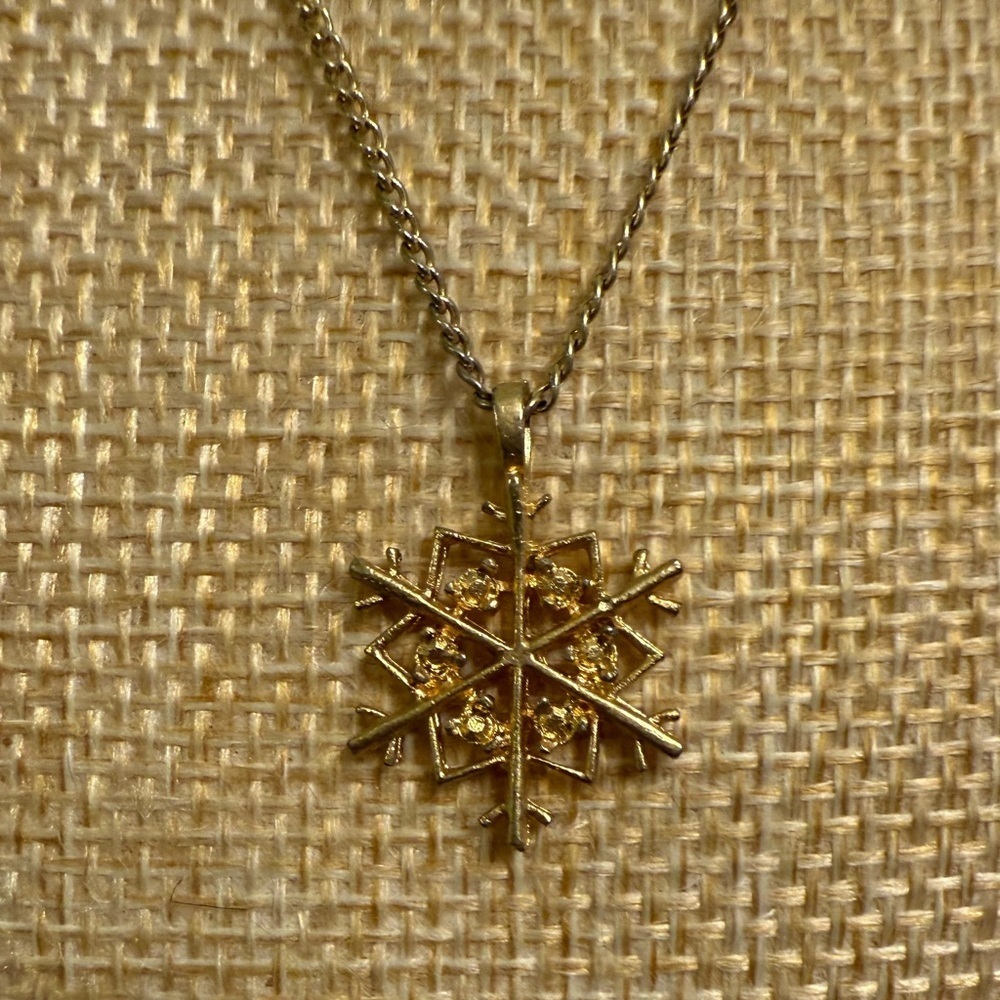 Gold Snowflake Pendant Necklace with floral clasp